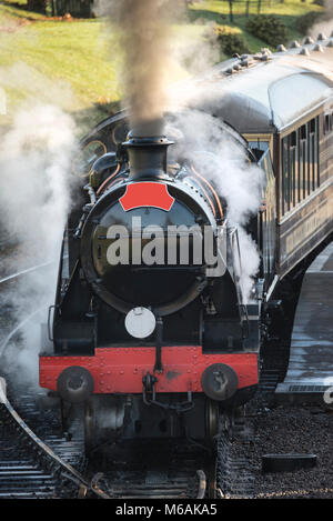 Old vintage steam railway engine with full steam blowing Stock Photo