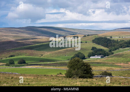 Blue summer sky & white clouds over isolated farm buildings & scenic rolling hills in beautiful, undisturbed countryside, North Yorkshire, England, UK Stock Photo