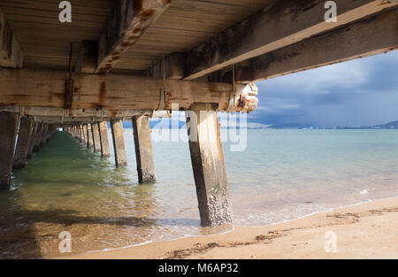 Under the Picnic Bay jetty, Magnetic Island, looking towards Townsville on a stormy summer's day. Stock Photo