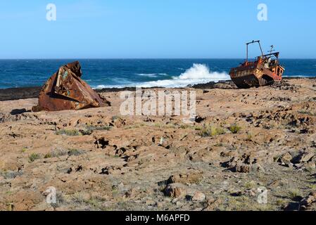 Rusty wreck of a fish trawler on the rocky shore, Cabo Raso, near Camarones, Chubut, Argentina Stock Photo