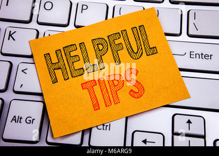 Conceptual hand writing text caption inspiration showing Helpful Tips. Business concept for Help in FAQ or Advice, written on sticky paper on the whit Stock Photo