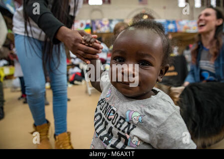 Philadelphia, Pennsylvania / USA: Young Morgan, 1 year, investigates the Girard College gymnasium on Martin Luther King Jr Day. January 15 2018. Stock Photo