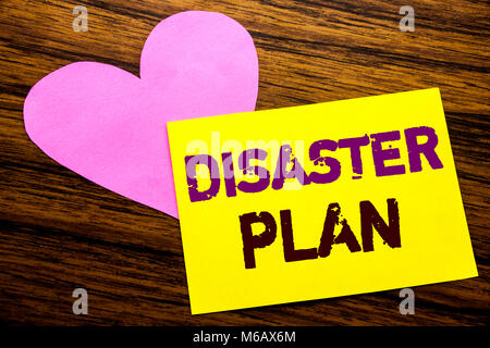 Hand writing text caption inspiration showing Disaster Plan. Business concept for Emergency Recovery written on sticky note paper, wooden background.  Stock Photo