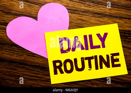 Hand writing text caption inspiration showing Daily Routine. Business concept for Habitual Lifestyle written on sticky note paper, wooden background.  Stock Photo
