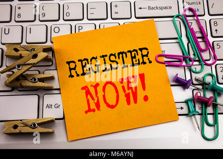 Writing text showing Register Now. Business concept for Join for Membership written on sticky paper on the white keyboard background. Stock Photo