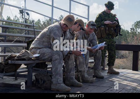 A group of Canadian Royal Air Force and New Zealand army joint terminal attack controllers discuss mission planning prior to combined training, Feb. 21, 2018, at Moody Air Force Base, Ga. Ally forces from the CRAF and NZA traveled to Moody AFB to train with the 75th Fighter Squadron on close air support from Feb. 20-23. (U.S. Air Force Stock Photo