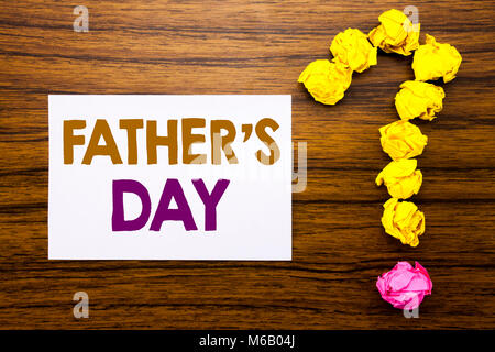 Handwritten text showing Father s Day. Business concept for Dad Celebration Event Written sticky note paper, wooden background with question mark from Stock Photo