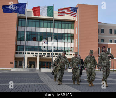 The NATO, Italian and American flag provide the backdrop for the discussion between US Army Europe Commander, Lt. Gen. Christopher Cavoli, 173rd Airborne Brigade Commander, Col. Jay Bartholomees, and USAG-Italy Commander, Col. Erik Berday in Vicenza, Italy. Stock Photo