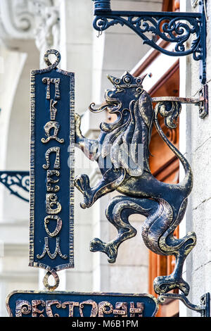 closeup metal wall sign of famous old restaurant Under Lion in age-old building Stock Photo