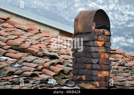 Closeup of an old rotting chimney of a small house in a village Stock Photo