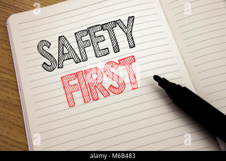 Handwriting Announcement text showing Safety First. Business concept for Safe Warning written on notebook with space on book background with marker pe Stock Photo