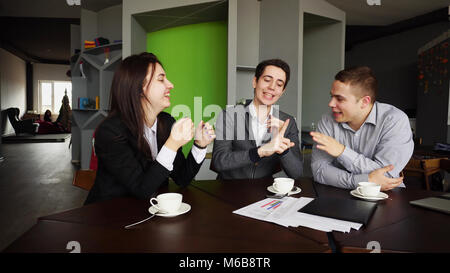 Funny young male and female students give five to each other and Stock Photo