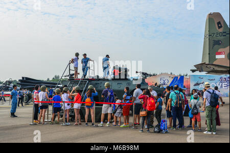 Singapore  - Feb 10, 2018. People visit an armoured car at the 2018 Singapore Airshow. Stock Photo