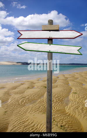 Double directional signs on a beach Stock Photo