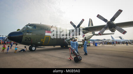 Singapore  - Feb 10, 2018. People looking at a Lockheed C-130 Hercules aircraft belong to the Singapore Air Force at the 2018 Singapore Airshow. Stock Photo