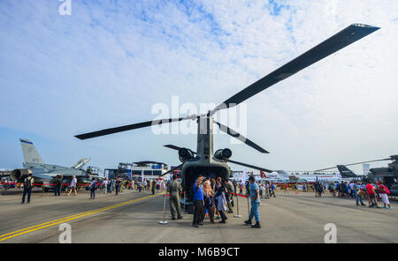 Singapore  - Feb 10, 2018. People looking at a helicopter belong to the Singapore Air Force sits on display at the 2018 Singapore Airshow. Stock Photo