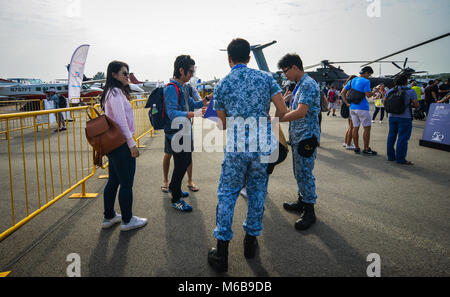 Singapore  - Feb 10, 2018. People taking with Singaporean soldiers at the 2018 Singapore Airshow. Stock Photo