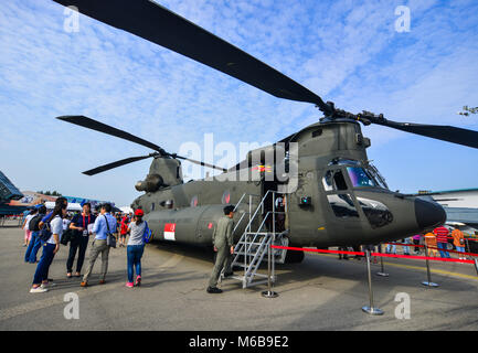 Singapore  - Feb 10, 2018. People visit a Boeing CH-47 Chinook helicopter belong to the Singapore Air Force at the 2018 Singapore Airshow. Stock Photo