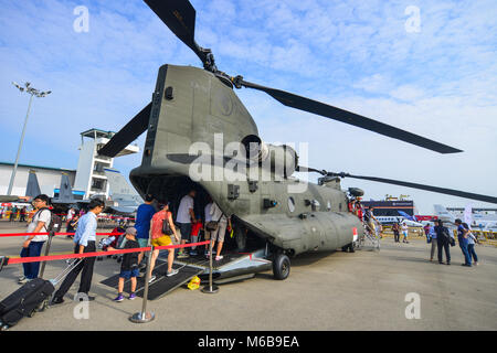 Singapore  - Feb 10, 2018. People visit a Boeing CH-47 Chinook helicopter belong to the Singapore Air Force at the 2018 Singapore Airshow. Stock Photo