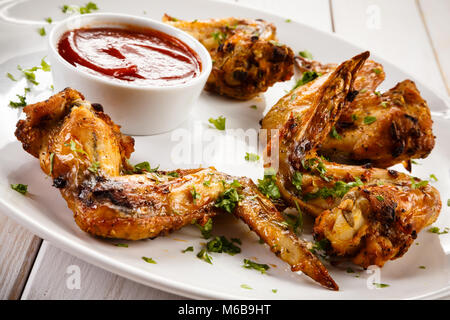 Grilled chicken wings on wooden table Stock Photo