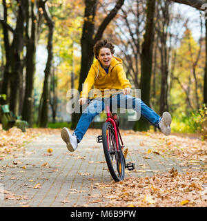 Urban biking - teenage boy and bike in city park Stock Photo