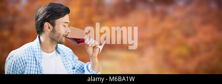 Composite image of man drinking red wine Stock Photo