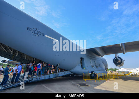 Singapore  - Feb 10, 2018. People visit a transport aircraft belong to the US Air Force on display at the 2018 Singapore Airshow. Stock Photo