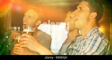 Happy friends toasting with pints of beer on patricks day Stock Photo