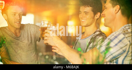 Happy friends toasting with pints of beer on patricks day Stock Photo