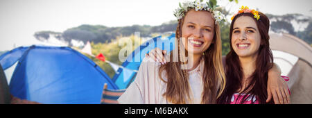 Composite image of women arm in arm with flower crown Stock Photo