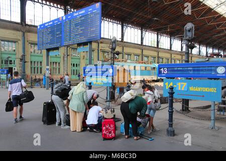 BUDAPEST, HUNGARY - JUNE 19, 2014: Travelers wait at Nyugati Railway Station in Budapest. It is the western train station and was opened in 1877. Stock Photo