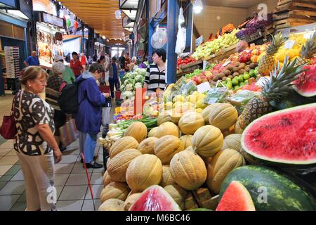 BUDAPEST, HUNGARY - JUNE 19, 2014: People visit Great Market Hall in Budapest. Opened in 1897, it remains the largest and oldest indoor market in Buda Stock Photo