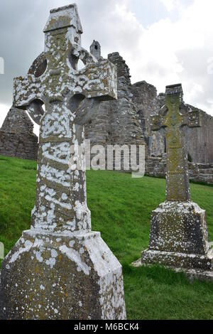 Celtic crosses and ruins of medieval stone churches in monastery of Clonmacnoise in Ireland. Stock Photo