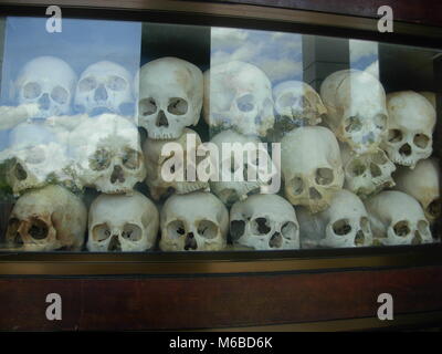 Skulls of dead cambodian prisoners exposed inside Choeung Ek Memorial (killing fields) in Phnom Penh, Cambodia Stock Photo