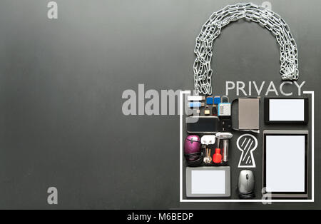 Privacy written inside a padlock made from devices including tablets, computer mouse, usb cards on a chalkboard background Stock Photo