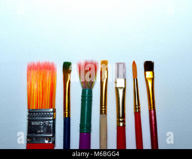 paint brushes in a line on a canvas Stock Photo