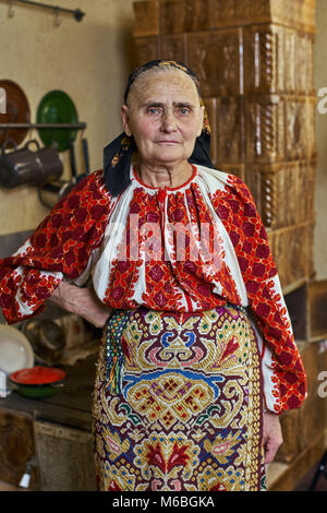 Old Romanian woman dressed in traditional costume Stock Photo