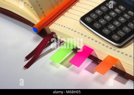 notebook with calculator, pen and stickers Stock Photo