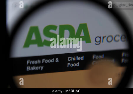 The Asda supermarket website seen through a magnifying glass Stock Photo