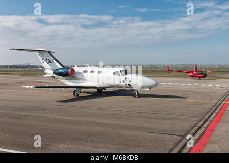 Dutch Lelystad Airport with Cessna jetliner and small helicopter Stock Photo