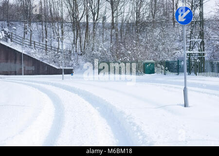Deep snow on road bend after heavy snowfall preventing traffic and vehicles from transporting or travelling Stock Photo