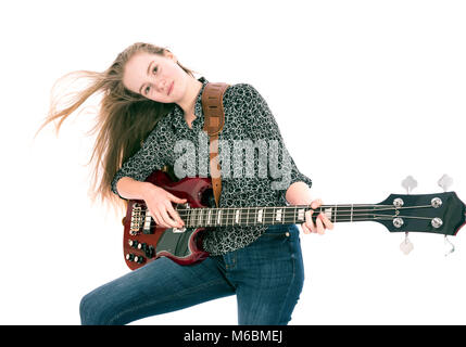 blond teen girl with electric bass guitar against white background Stock Photo