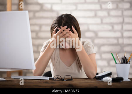 Businesswoman Suffering From Migraine Touching Her Forehead Stock Photo