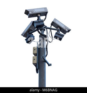 Three CCTV surveillance cameras on a pole outdoors on white background Stock Photo