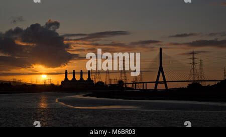 Suspension bridge, power station and pylons at Deeside, North Wales on the banks of the river Dee Stock Photo