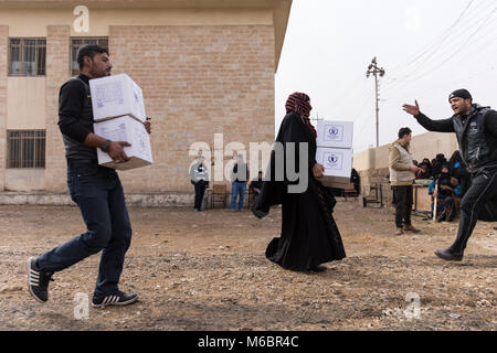 Mosul, Iraq. 8th December 2016 - Mosul locals carry aid to their homes as an operation to remove Daesh is underway - Â© Ty Faruki Stock Photo