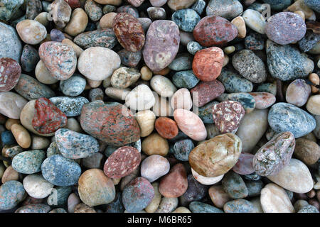 A close up view of colorful pebbles on Lochinver Beach along the west coast of Scotland. Stock Photo