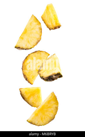Falling slices of pineapple isolated on white. Stock Photo