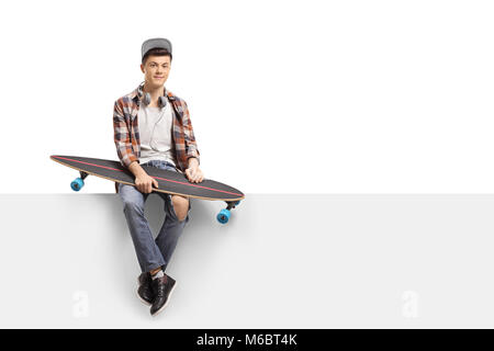 Teenage skater with a longboard sitting on a panel isolated on white background Stock Photo