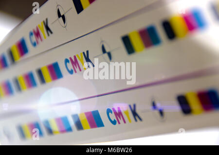 CMYK test printed on white paper with lights effect. Cyan, magenta, yellow, black and registration mark. Stock Photo